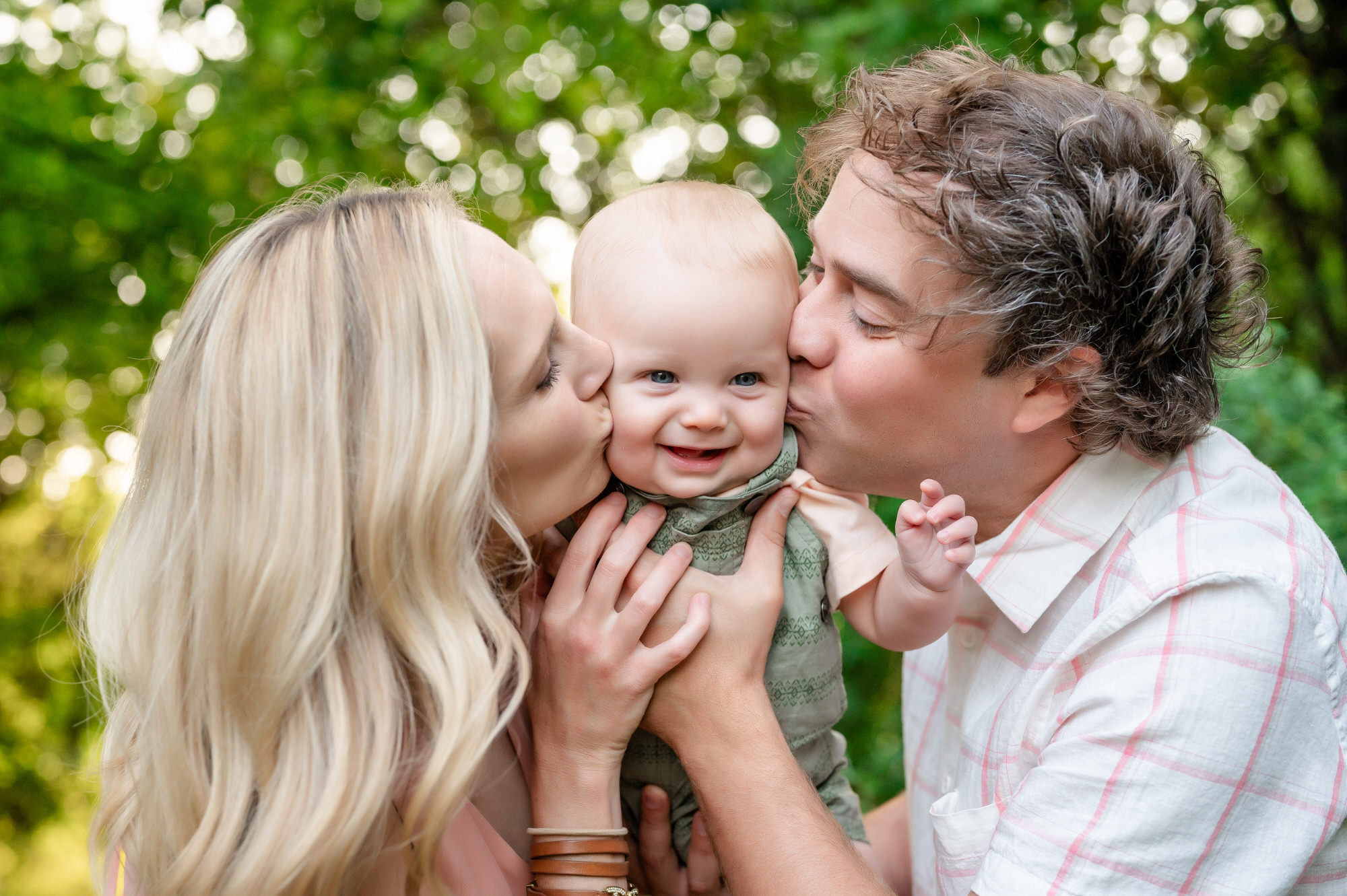 parents kissing baby cheeks during family photos in pittsburgh • Family