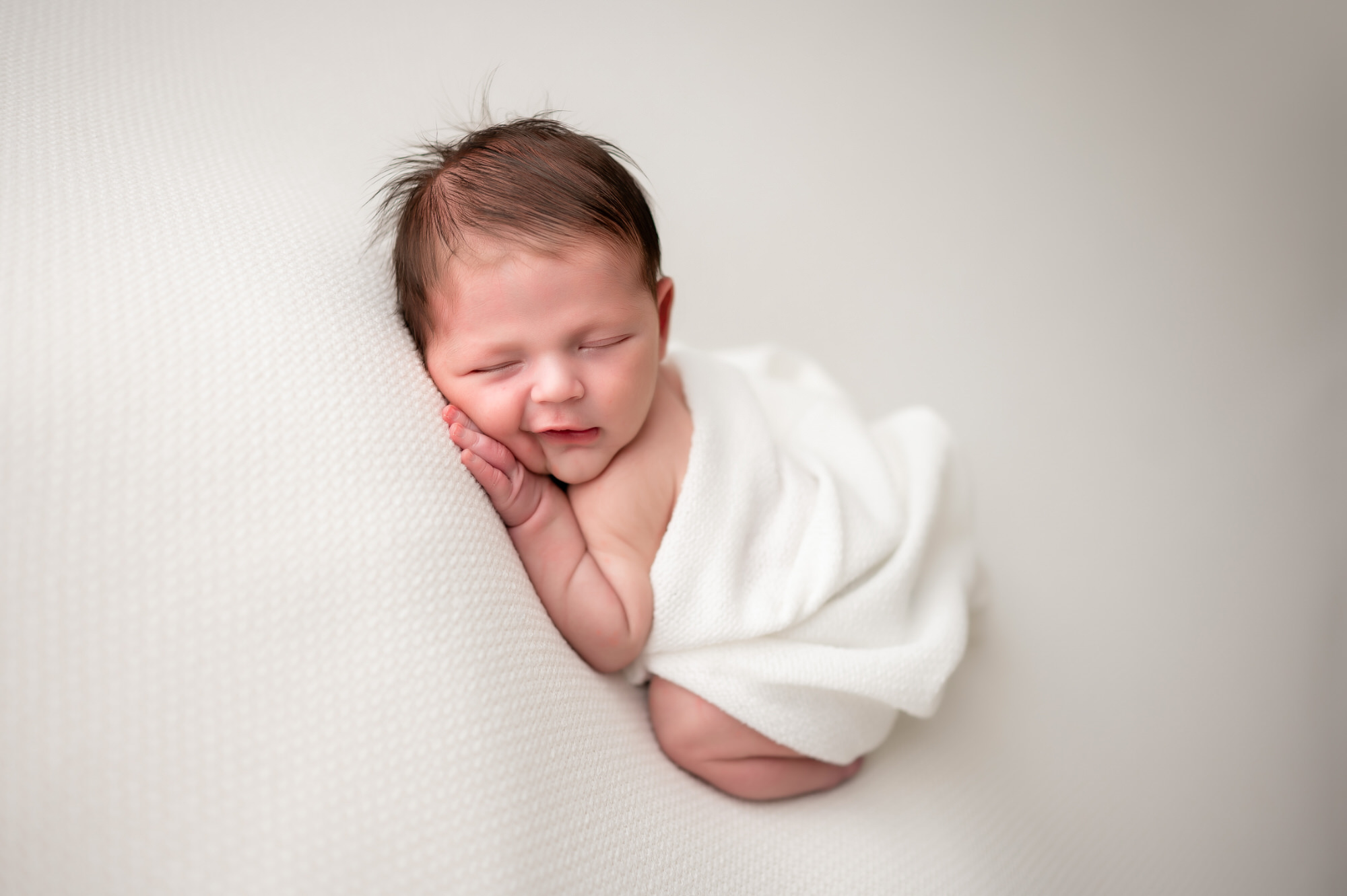 baby smiling during newborn photos • Baby