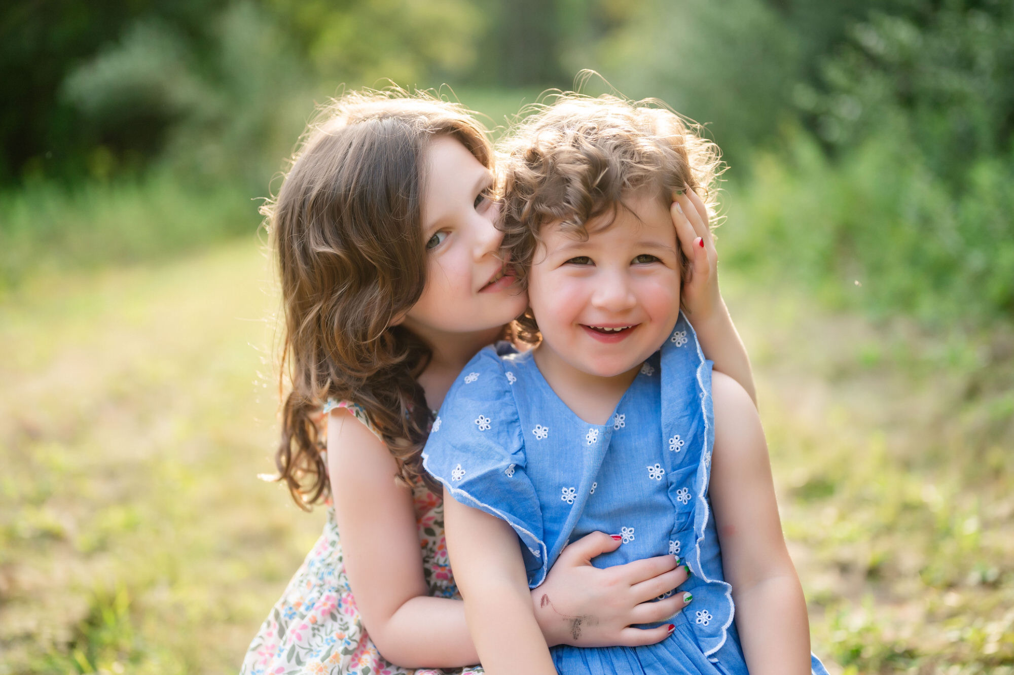 sisters smiling during outdoor family photo session in beaver county pennsylvania • Family