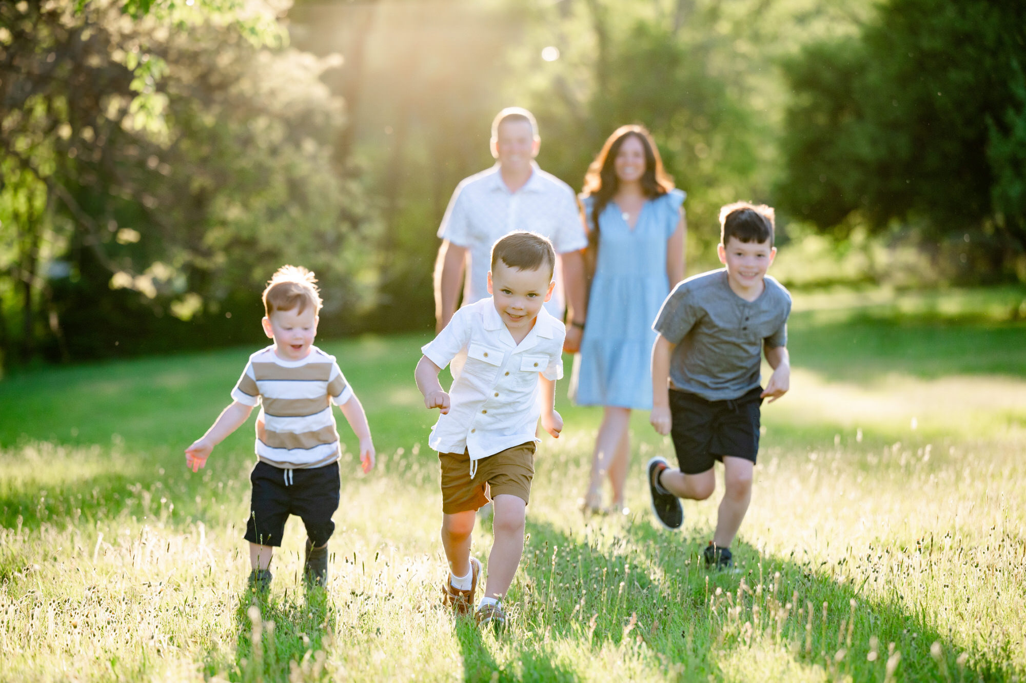 three boys running to camera during pittsburgh family photo session • Family