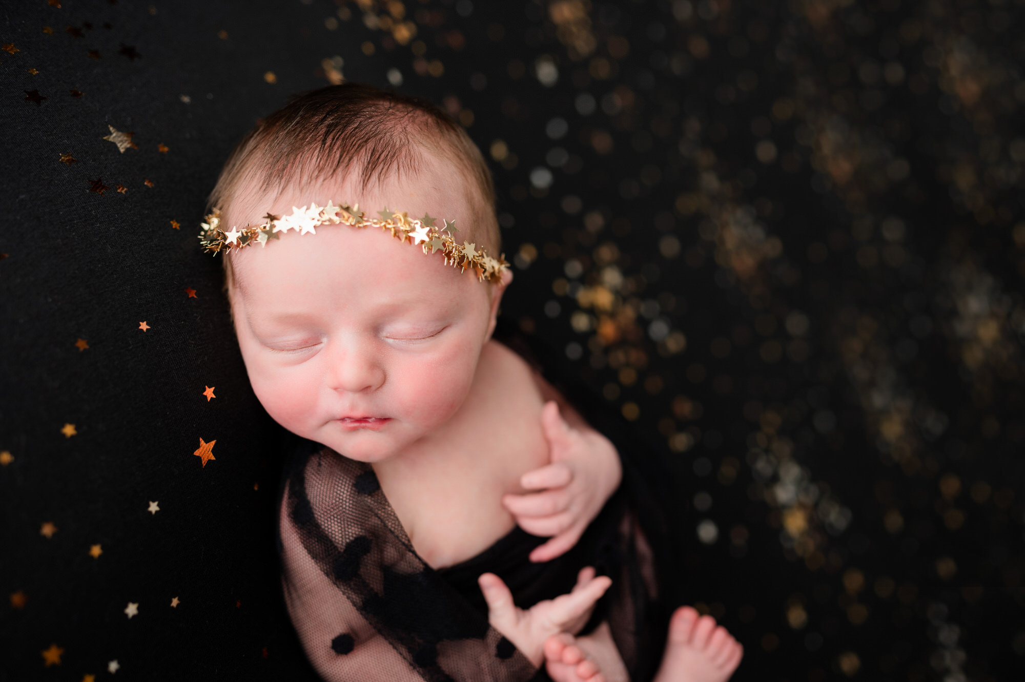 newborn baby photo in studio with gold stars • Baby