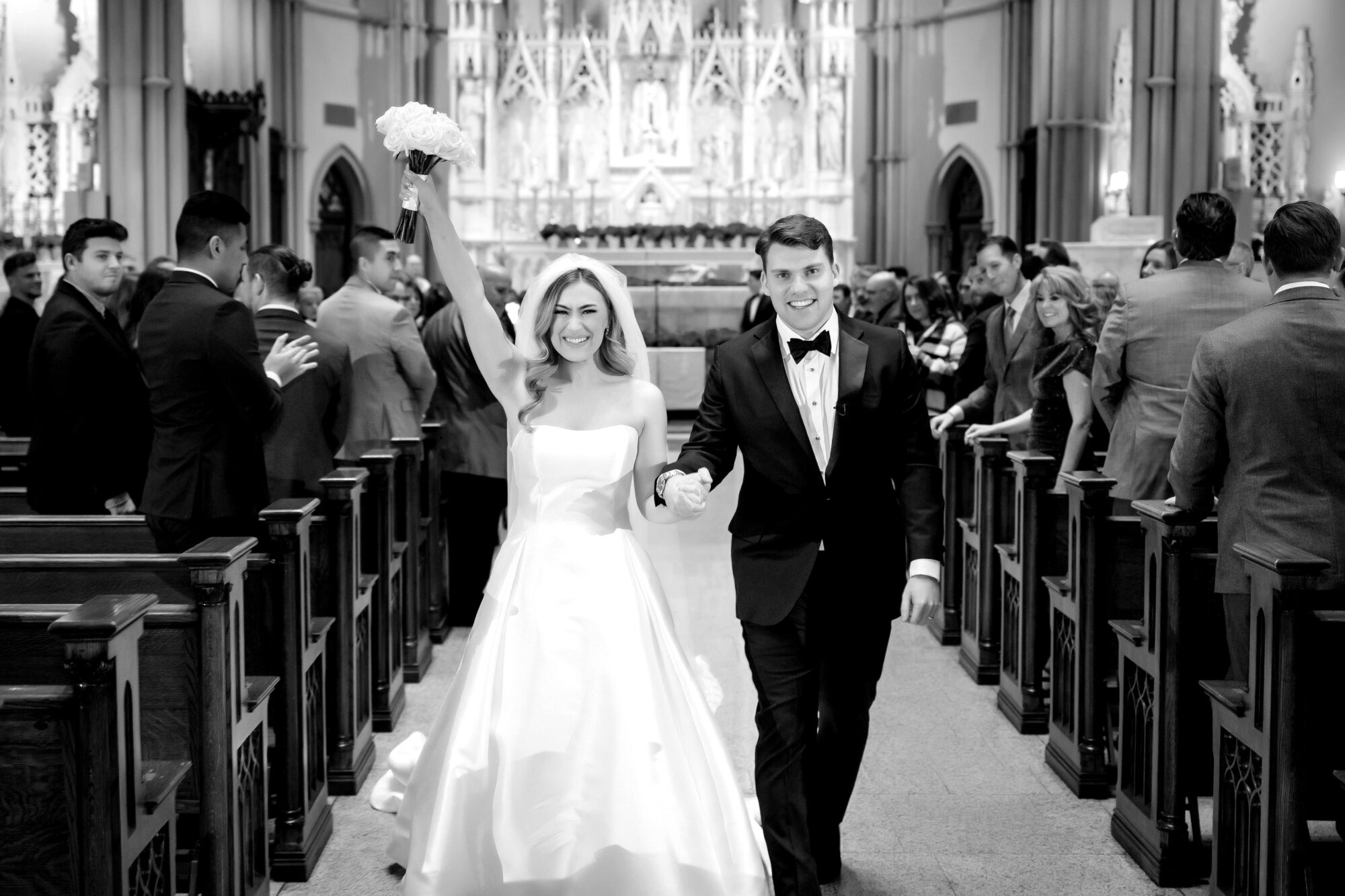 bride and groom smiling as they come down the aisle married at st paul cathedral in pittsburgh • Stunning Duquesne Club Wedding Photos - An Elegant Wintery January Pittsburgh Marriage
